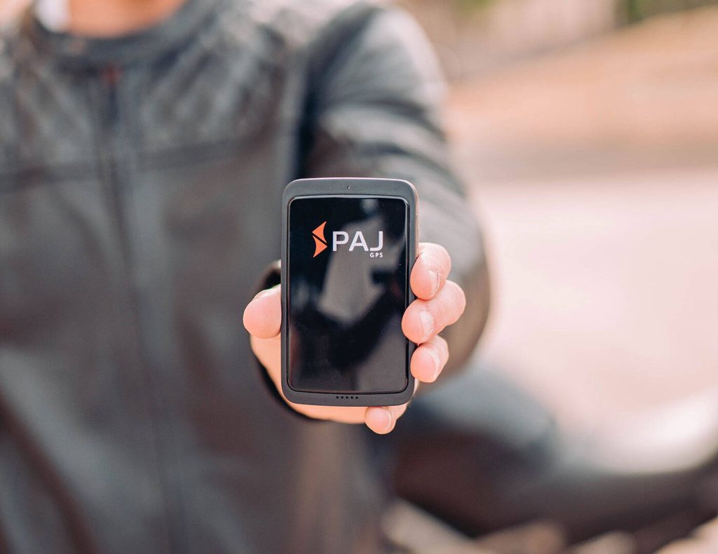 a man showing mini gps tracker