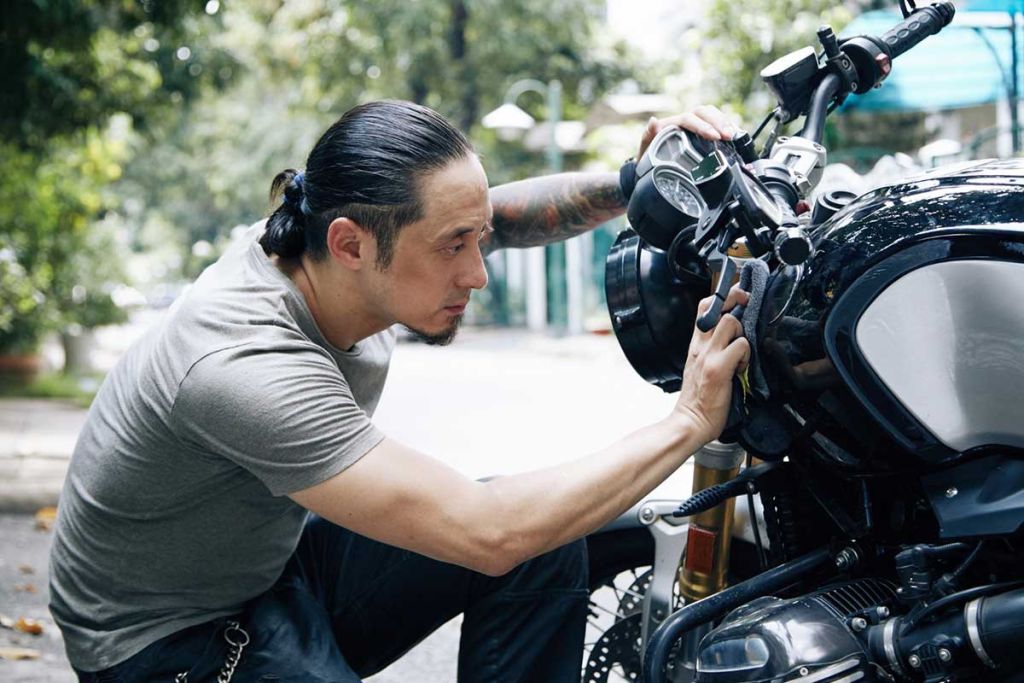 A man reparing his bike for Spring Riding Season